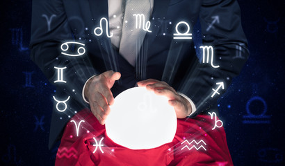 Young handsome astronaut looking for inspiration in his crystal magic ball
