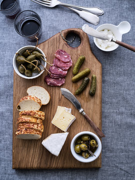 Charcuterie and cheeses on a wooden board