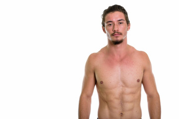 Fototapeta premium Studio shot of young handsome man shirtless isolated against whi