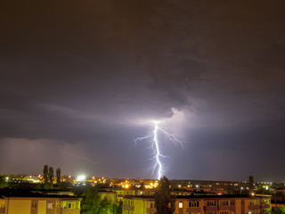 Lightning flash over a city, Thunderstorm , electricity blast storm