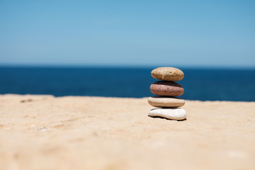 stack of pebbles on right symbolizes balance and harmony