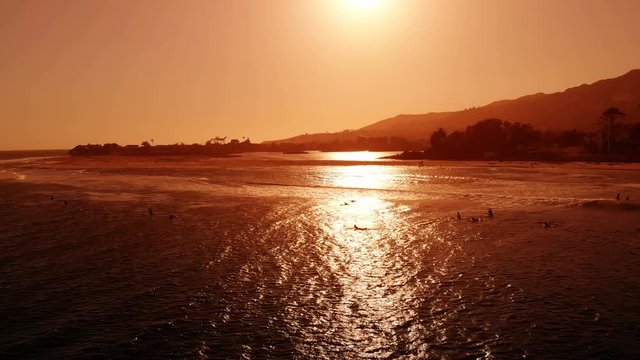 Surfers on Sunset Waves Aerial Shot of Malibu California