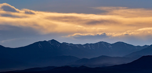 Panorama of the mountains on a hazy, but colorful sunset evening