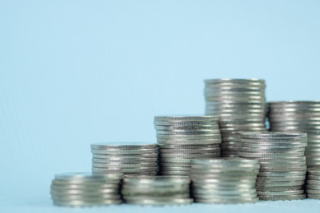 Step of coin stack with passbook or account book on wooden working table, savings and banking...