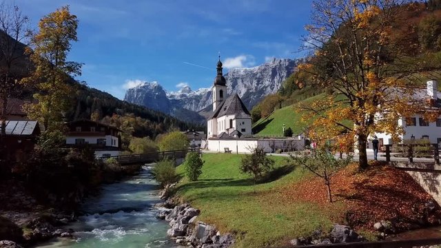 Flight over famous Parish church St. Sebastian, in Ramsau, Berchtesgaden, Bavarian Alps Germany.