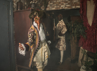 Actors in steam punk masks and antique costumes indoor.