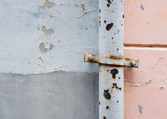 Rusty pipe against a wall