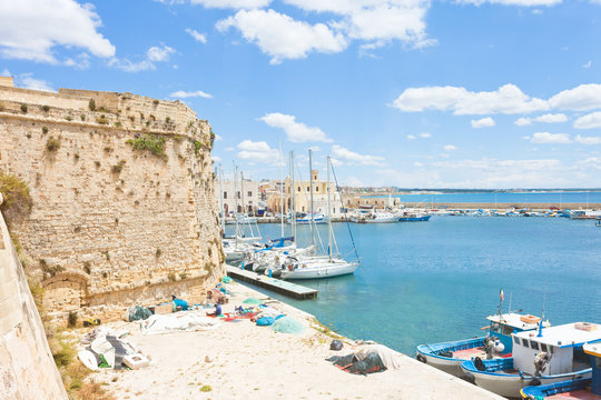 Gallipoli, Apulia - Sailing boats at the harbor near the historical city wall