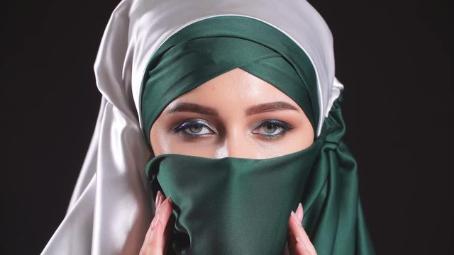Portrait of an arabic young woman with her beautiful eyes in traditional islamic cloth niqab.