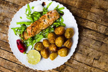 Salmon steak with young potato on a plate