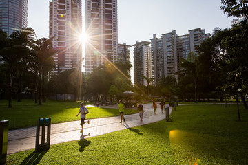 People are jogging in the morning in city park - 204688545