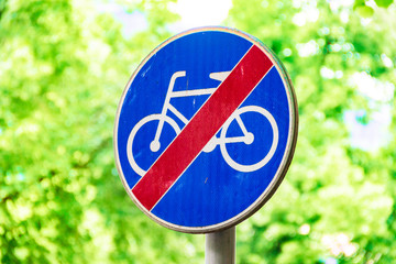Signs for cyclists, road sign against a background of green trees