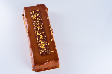Chocolate cake decorated with nuts on white background.View from above, copy space for text.