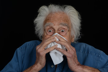 Senior man Blows his Nose