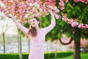 Woman enjoying cherry blossom season in Paris, France