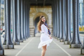 Woman in white dress on Bir-Hakeim bridge in Paris, France