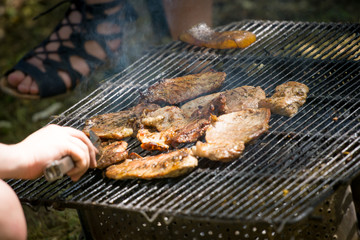 Barbecue lunch. Grilled meat chops in a black cast iron pan, close-up