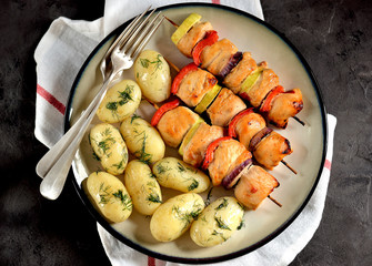 baked chicken breast shish kebab with red onion, zucchini, red pepper and boiled baby potatoes with dill and olive oil.