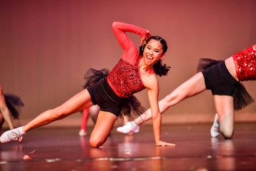 Cheerleader and dancer performing on stage during a show