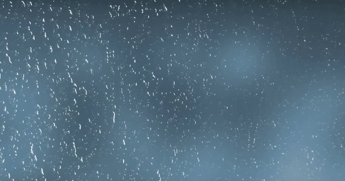 rain drops falling down on glass blue background, water droplets on window glass