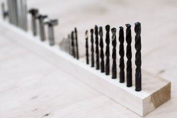 A set of drill bits stand in a row