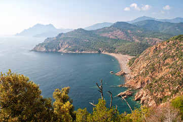 View of the clear sea and rocky hills in Corsica