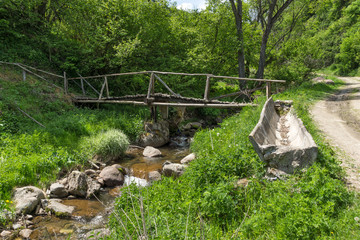 Obraz premium Wooden bridge over Fotinovo River near village of Fotinovo in Rhodopes Mountain, Pazardzhik region, Bulgaria