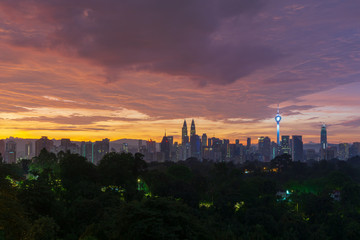 Majestic sunrise over Petronas Twin Towers and surrounded buildings in downtown Kuala Lumpur, Malaysia.