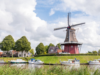 Canal and windmill on fortifications of fortified town of Dokkum, Friesland, Netherlands