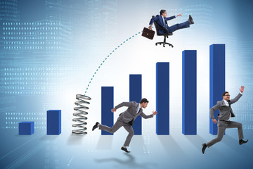 Business people jumping over bar charts