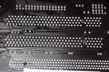 The reverse side of the microboard. Contacts solder. Soldered parts. Electronic board with electrical components. Electronics of computer equipment