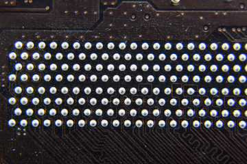 The reverse side of the microboard. Contacts solder. Soldered parts. Electronic board with electrical components. Electronics of computer equipment