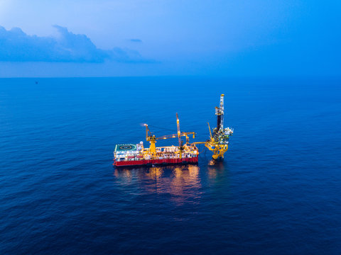 Aerial View of Tender Drilling Oil Rig (Barge Oil Rig) in The Middle of The Ocean at Sunset Time