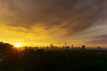 Majestic sunrise over Petronas Twin Towers and surrounded buildings in downtown Kuala Lumpur, Malaysia