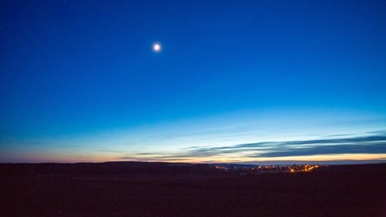 Late evening sky over village near fields