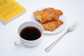 black coffee and fresh baked croissants