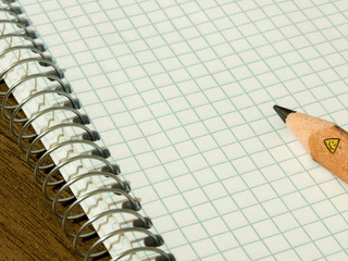 mathematical square notebook and pencil on it