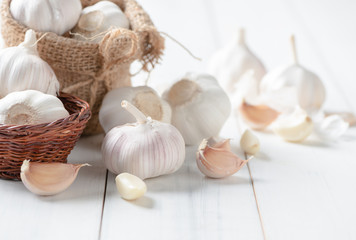 Garlic on white wood background,