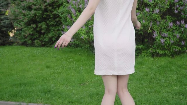 Young attractive girl dizzy in the garden