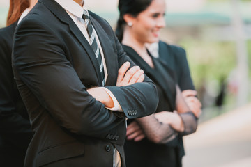 Smart Team! business people standing with arms crossed wearing formal black suit