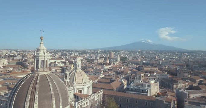 Beautiful aerial view of the Catania city with main Cathedral and Etna volcano on the background. Amazing old town view.
