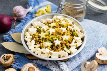 Russian traditional buckwheat porridge with mushrooms, garlic, onion, tofu cheese and vegetables. Cook fun art. Raw, vegan, vegetarian healthy food concept.