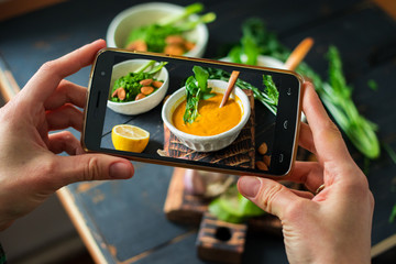 Phone photography of food. Woman hands take photo of lunch with smartphone for social media....