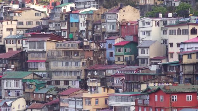 Panning shot of the colorful buildings, schools, homes, offices, temples of shimla. Shot during the early morning the shot highlights the concrete, slant roofed and small windowed buildings built to