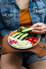 Buddha Bowl with fresh vegetables. Cucumbers, tomatoes, radish, cabbage, avocado, almonds. Top view. Organic natural products. Raw, vegan, vegetarian healthy food