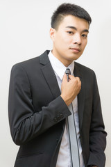 Attractive business asian man posting