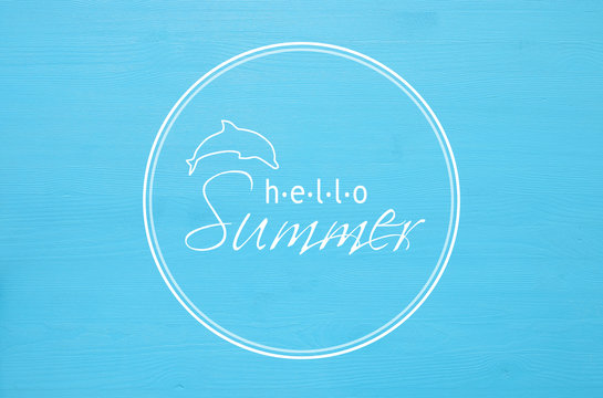 vacation and summer concept with text HELLO SUMMER over blue wooden background.