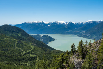 Fototapeta na wymiar view of Howe Sound and far away snow covered mountains on top of Stawamus Chief