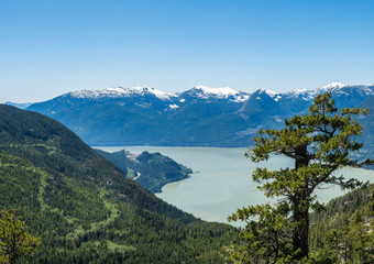 view of Howe Sound and far away snow covered mountains on top of  Stawamus Chief