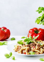 Pasta with meat tomato sauce on a plate, white background, selective focus